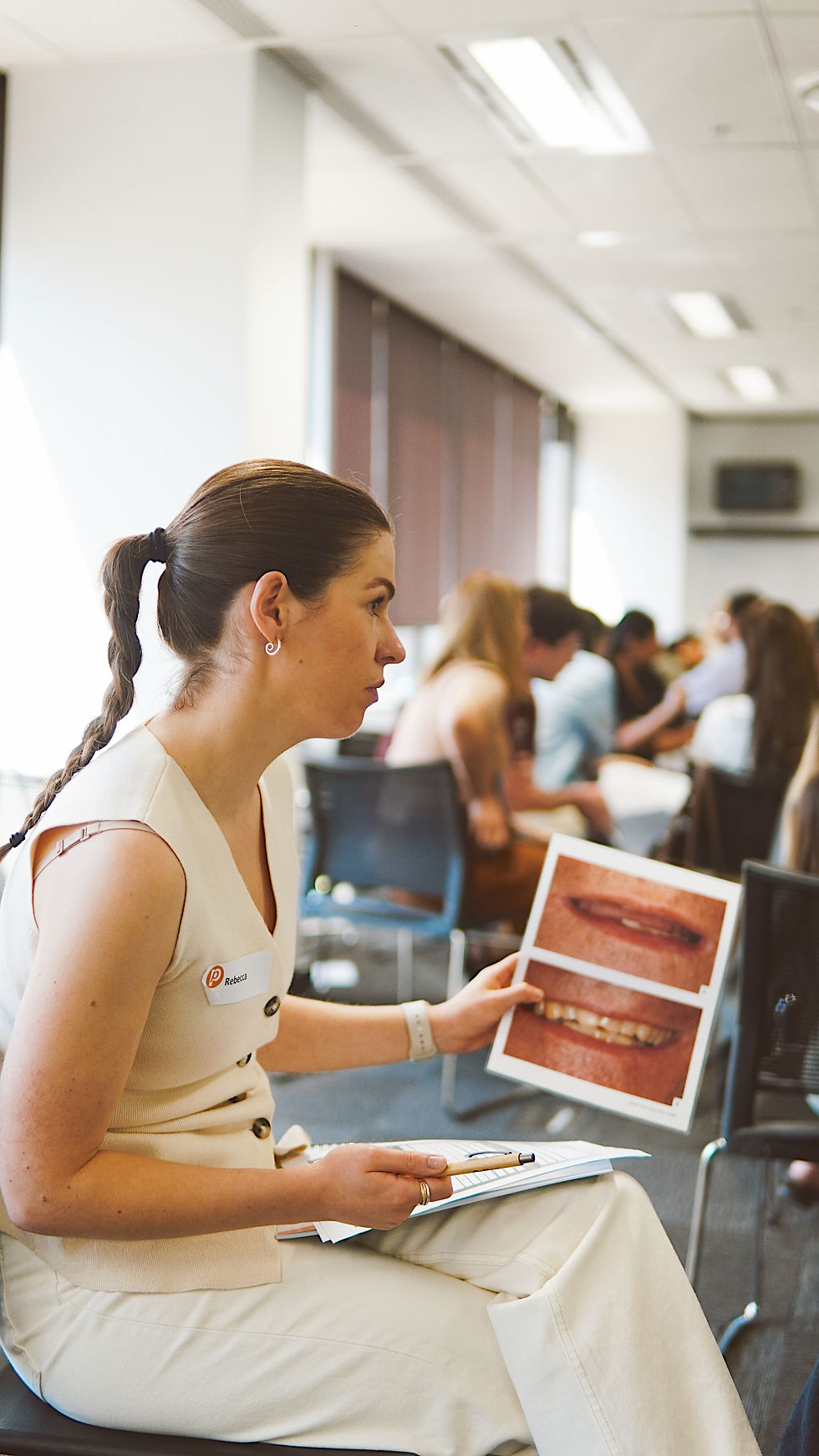 Primespeak attendee holding an image of teeth